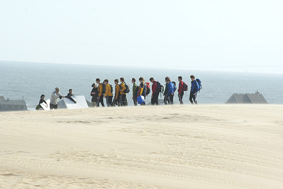 Hark! The Lost Colonists! They have somehow acquired backpacks among the sands!